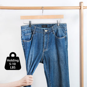 Nature Smile pack of 10 wooden hangers for organized wardrobe storage.