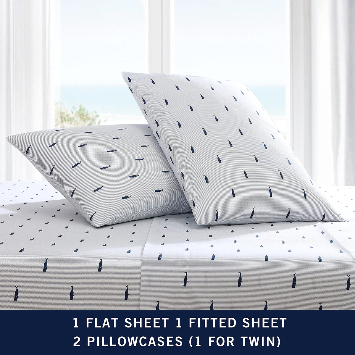 Nautica home display shows coastal-inspired bedding in whale stripe blue.