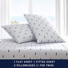 Nautica home display shows coastal-inspired bedding in whale stripe blue.