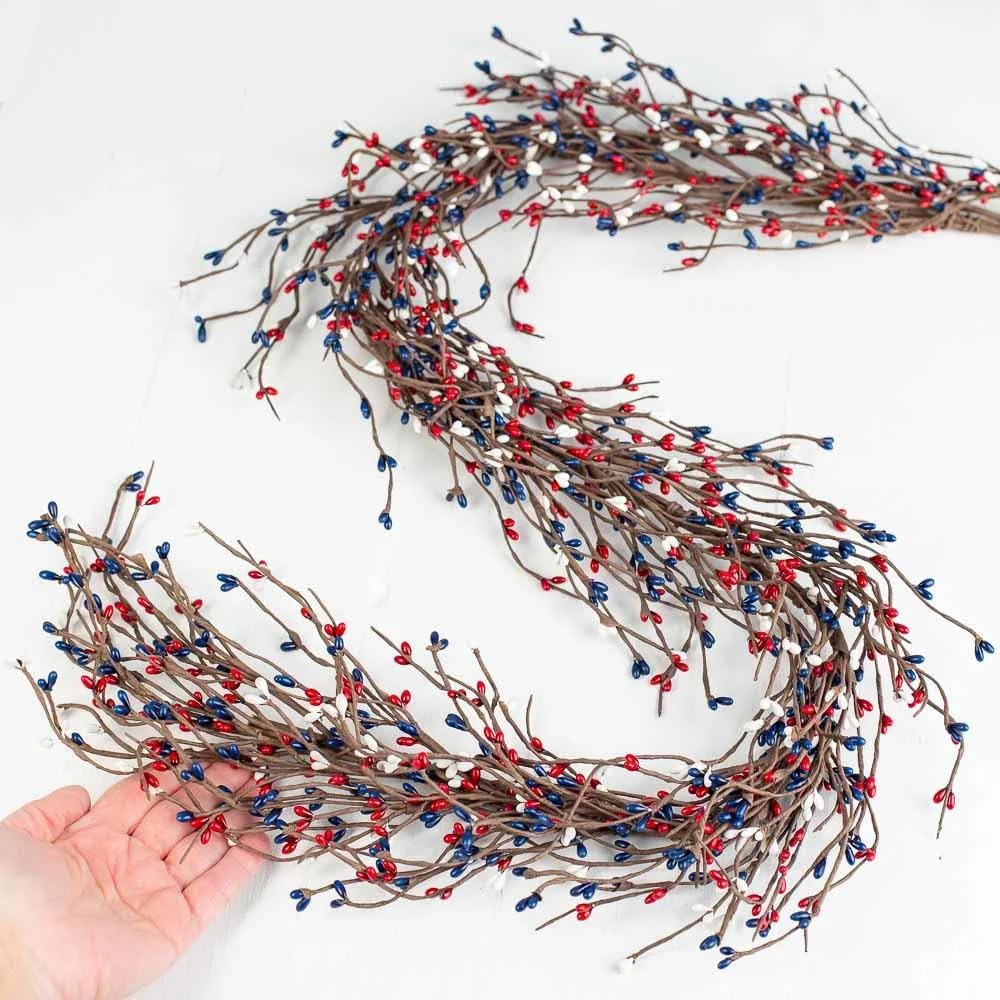 NeoL'artes rustic branch garland with red, white, and blue berries offers flexible indoor styling.