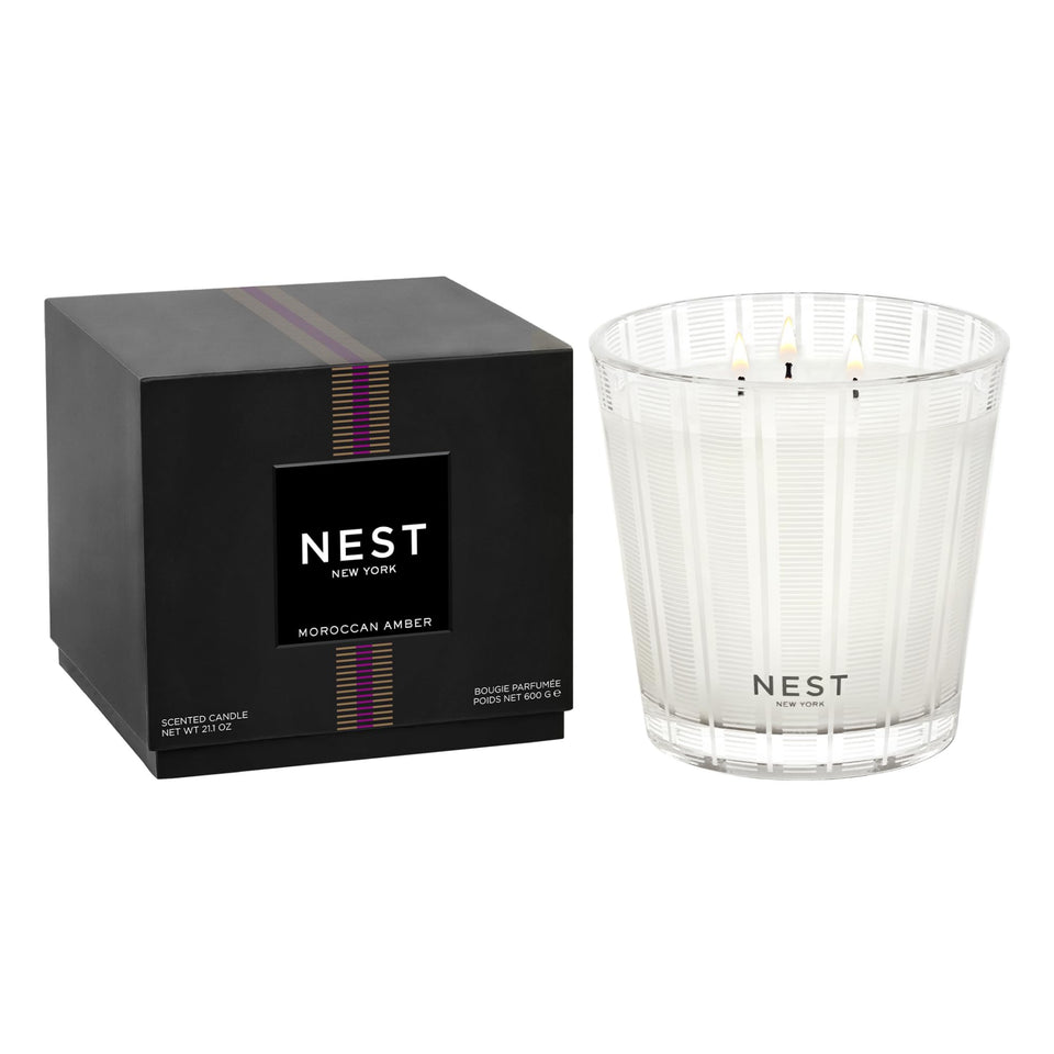Nest New York Moroccan Amber candle side view with warm glow enhances ambience.
