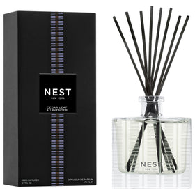 NEST New York Reed Diffuser bottle on a clear glass holder for a serene living space.
