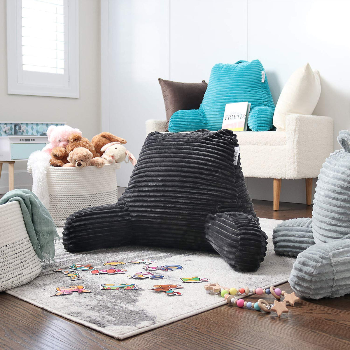 Nestl reading pillow dark grey color complements bedding and decor.