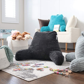 Nestl reading pillow dark grey color complements bedding and decor.