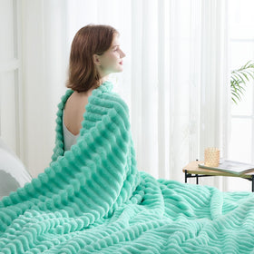 Newcosplay Aqua Ribbed Throw Blanket draped on a bed for elegant warmth