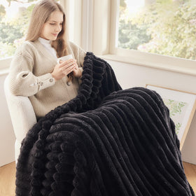 NewCosplay black ribbed twin blanket folded neatly for compact, ready-to-use storage