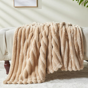 NEWCOSPLAY brown ribbed twin blanket draped over sofa for warmth.