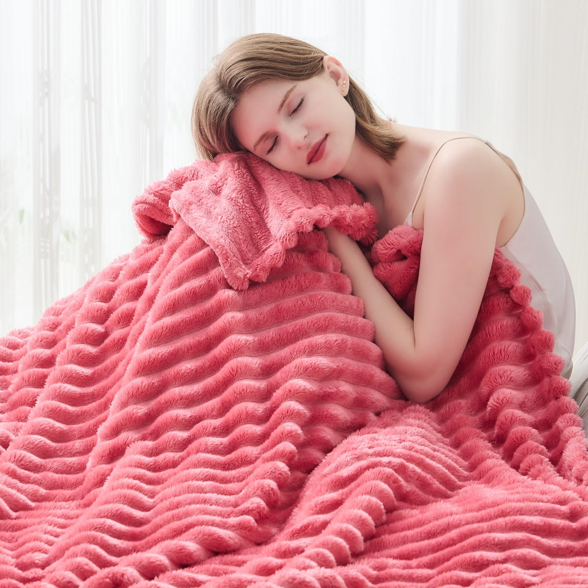 NEWCOSPLAY coral pink ribbed throw blanket folded on a bed
