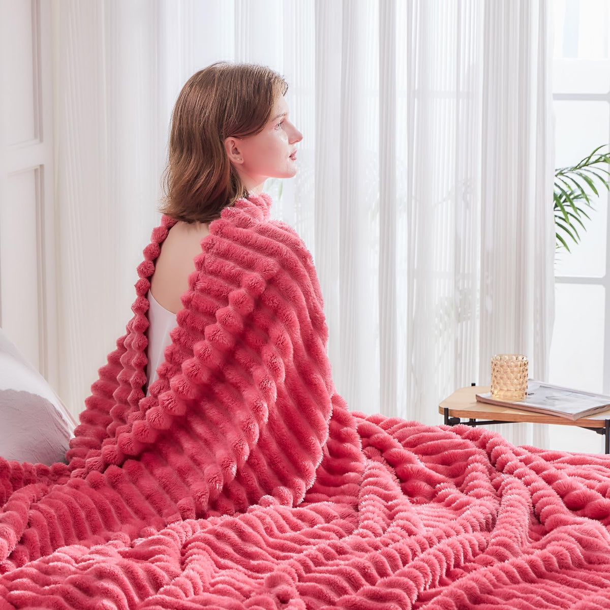 NEWCOSPLAY coral pink ribbed throw blanket in a decorative setting