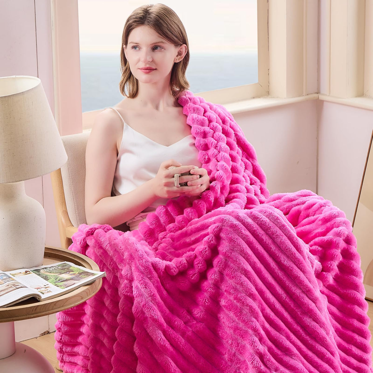 Close-up of NEWCOSPLAY hot pink ribbed throw texture showing ultra-soft microfiber