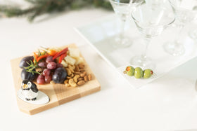 Nora Fleming olive mini base showcases interchangeable decor for festive gatherings