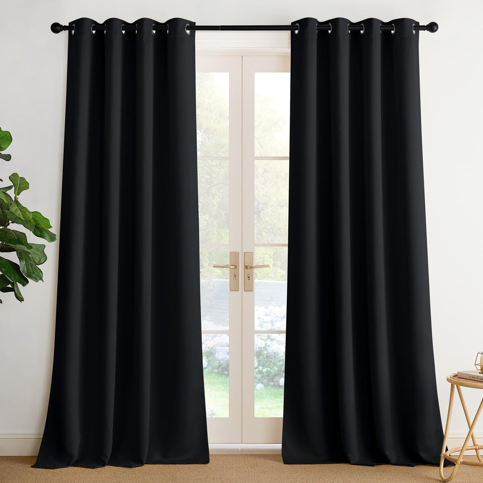 NICETOWN room darkening curtains in black with silver grommets enhance privacy and modern room look.