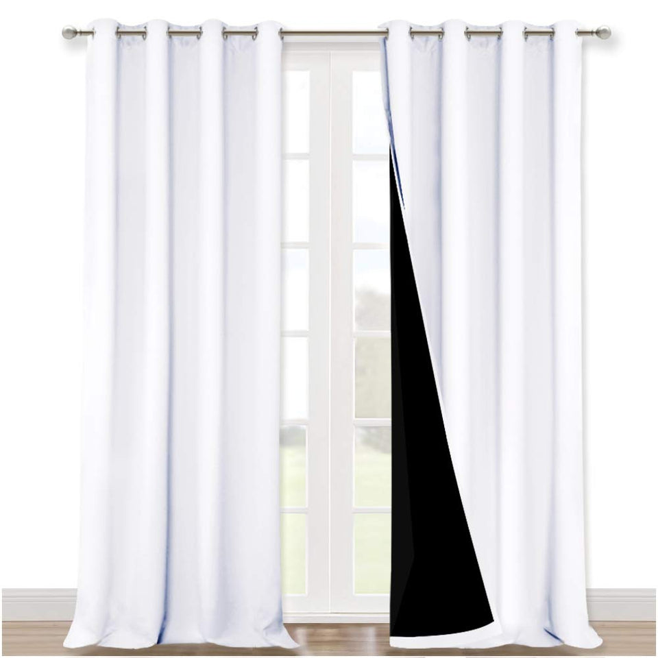 NICETOWN two-panel white blackout curtains, front view, block daylight and glare.
