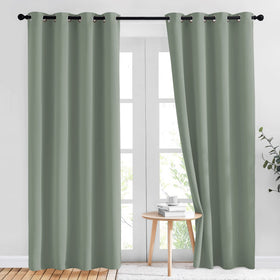NICETOWN sage green blackout curtains in 84-inch two-panel set for a dark, restful bedroom.