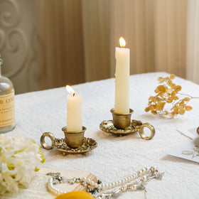 Close-up of vintage metal candlesticks with distressed gold finish