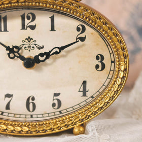 NIKKY HOME vintage tabletop clock gold on a living room shelf