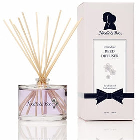 Noodle & Boo reed diffuser bottle releasing a soft, calming fragrance in any room.