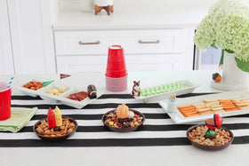 Nora Fleming touchdown ceramic mini pairs with bases for interchangeable season-inspired displays.