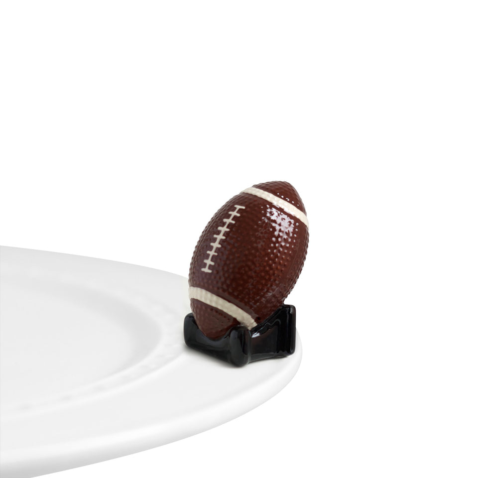 Nora Fleming Touchdown mini on ceramic base adds festive game-day ambiance to any space.