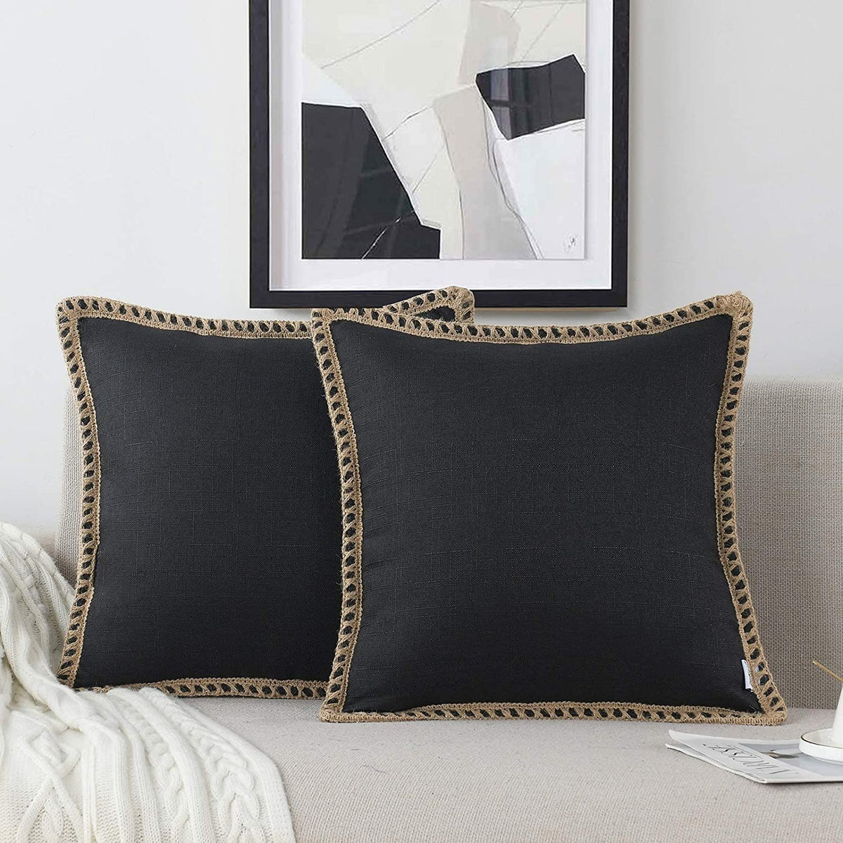 NordECO HOME farmhouse pillow cover in black adds rustic charm to a sofa.
