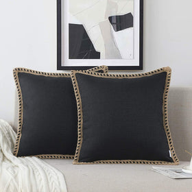 NordECO HOME farmhouse pillow cover in black adds rustic charm to a sofa.
