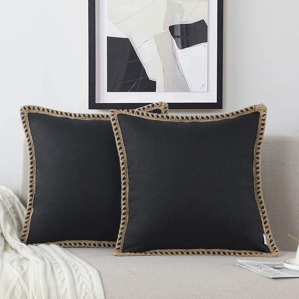 NordECO HOME farmhouse pillow cover in black adds rustic charm to a sofa.