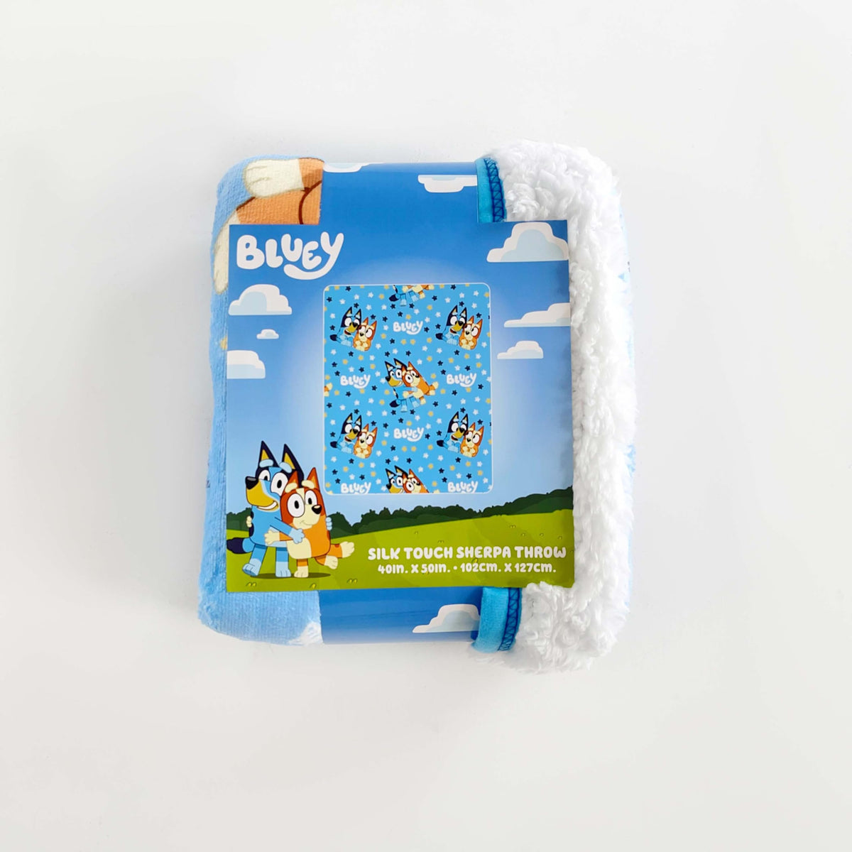 Northwest Bluey blanket on sofa shows soft sherpa backing