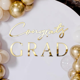 Novabright Congrats Grad sign backdrop in gold mirror for graduation photos.