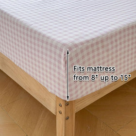 NSNLGSGC Farmhouse-style bedroom setup with gingham and ruffles for warm ambiance.