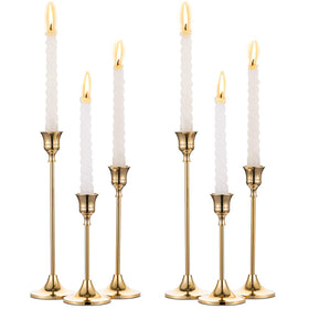 NUPTIO brass gold taper candle holders arranged as a centerpiece for a sophisticated dining table.