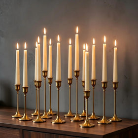 Nuptio 15-piece gold candlestick set on mantel for timeless elegance.