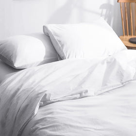 Nuzzle envelope-closure design protects pillows and simplifies bed making.