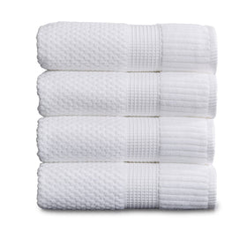 NY Loft Trinity white towels folded to show generous 30x52 size and plush texture.
