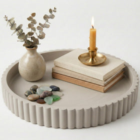 OAKOA round concrete tray on a coffee table used as a stylish centerpiece
