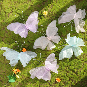OBBOLO 3D hanging butterflies in dreamy pastel colors for a whimsical party backdrop.