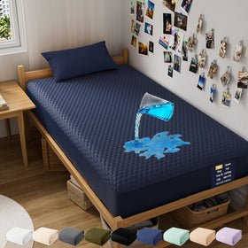 OhGeni waterproof mattress protector on a twin bed with navy blue cover for dry mornings.