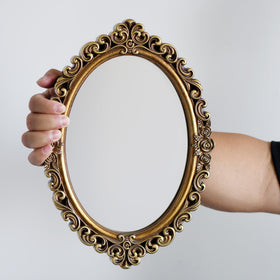 OIGUMR gold oval mirror adds Rococo charm to any room.
