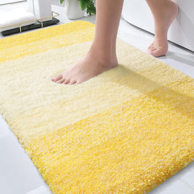 OLANLY bath mat in yellow with ultra-soft microfiber for luxurious comfort after a shower.
