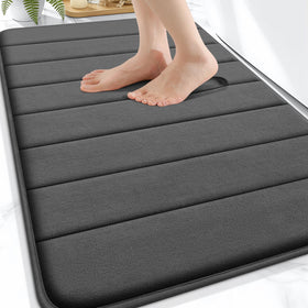 OLANLY Memory Foam Bath Mat 30x20 with absorbent surface for dry feet after showers.