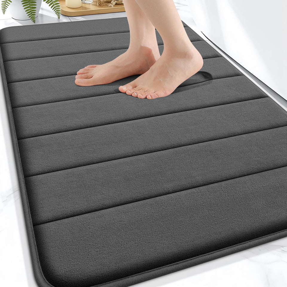 OLANLY Memory Foam Bath Mat 30x20 with absorbent surface for dry feet after showers.