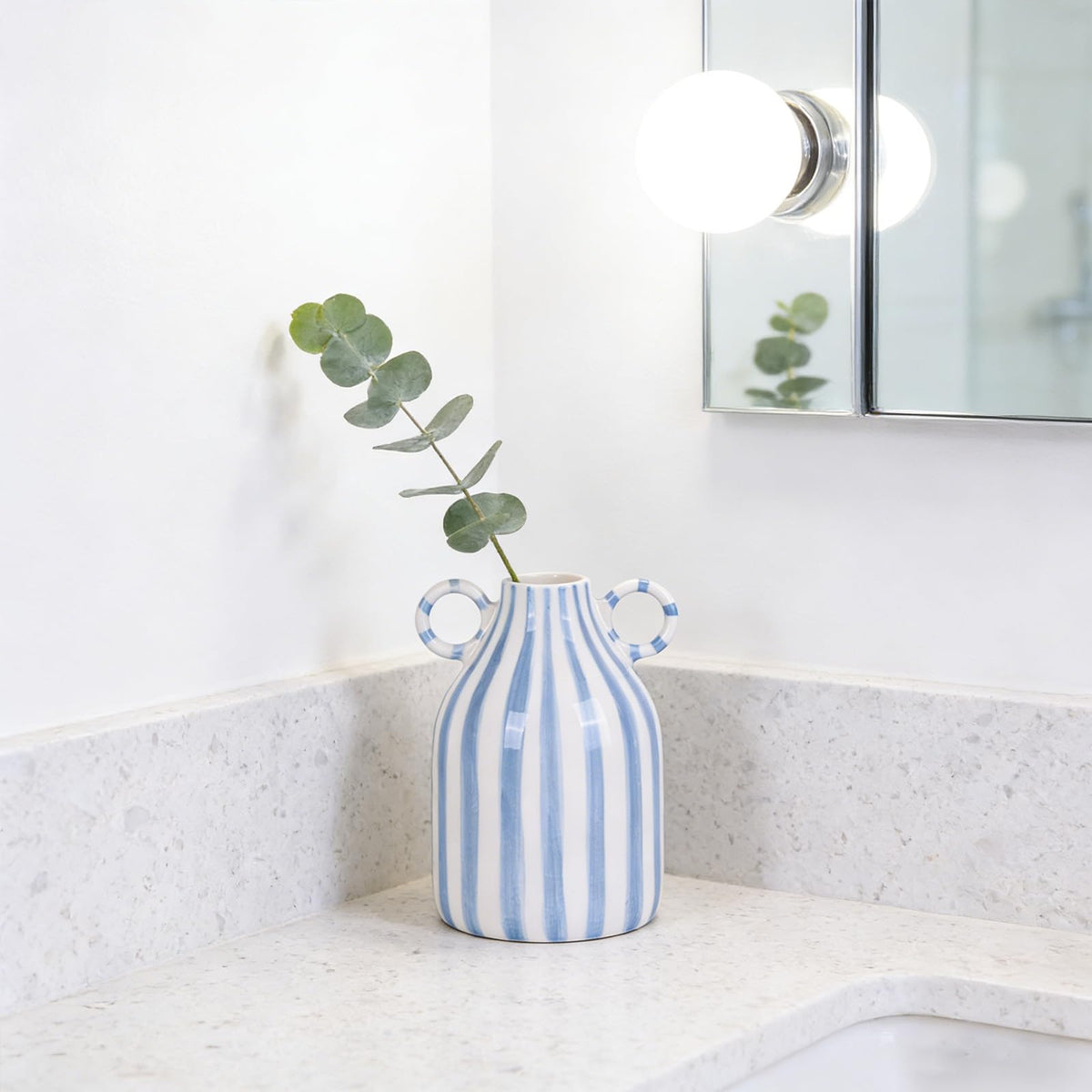 oliruim blue and white striped vase close-up shows hand-painted pattern
