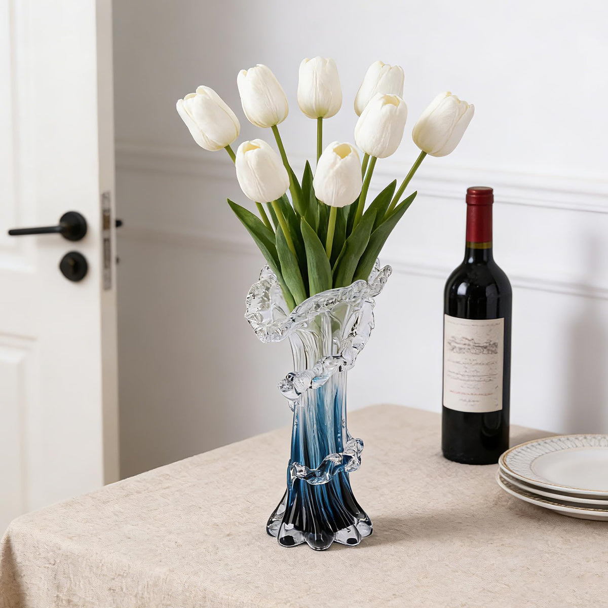 oliruim vase on dining table complements coastal decor and blooms beautifully.