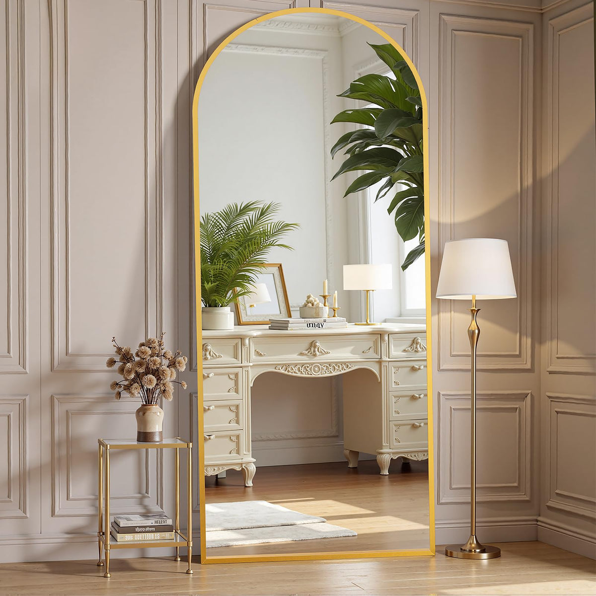 OLIXIS arched full-length mirror with gold frame reflecting a bright bedroom scene