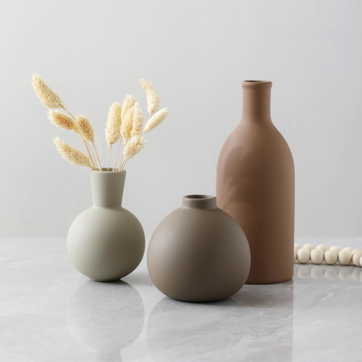 OOIT ceramic vases hold fresh flowers with a waterproof interior coating.