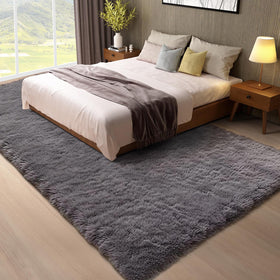 Ophanie shag rug beside sofas adds comfort and quiet underfoot.