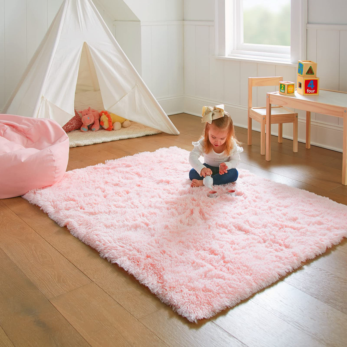 Ophanie Pink Rug for baby's play area supports barefoot comfort and security.