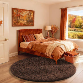 Ophanie round rug 4ft brown circle adds cozy ambience to living spaces.