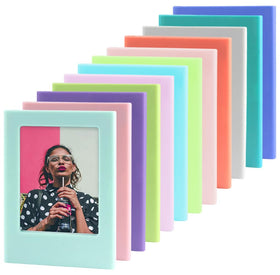 Orga'Neat magnetic frame on fridge displaying Instax Mini photos for quick memories.