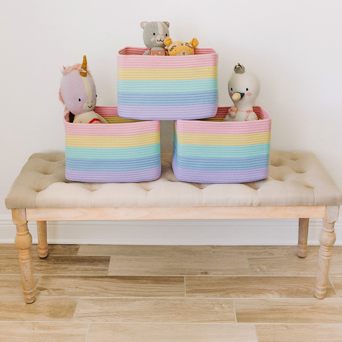 OrganiHaus pastel rainbow baskets holding towels in a bright nursery