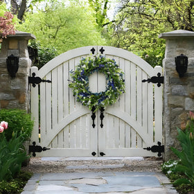 Orilium wreath with wheat stalks and blue leaves adds natural outdoor texture.